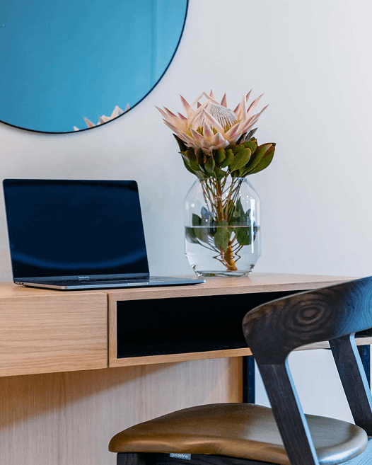 Totalstay guest stepping onto a city-view balcony